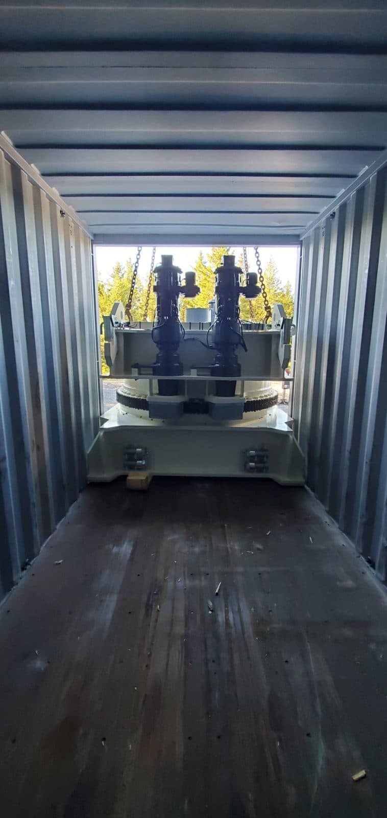 Tower crane slewing unit being lifted out of a shipping container