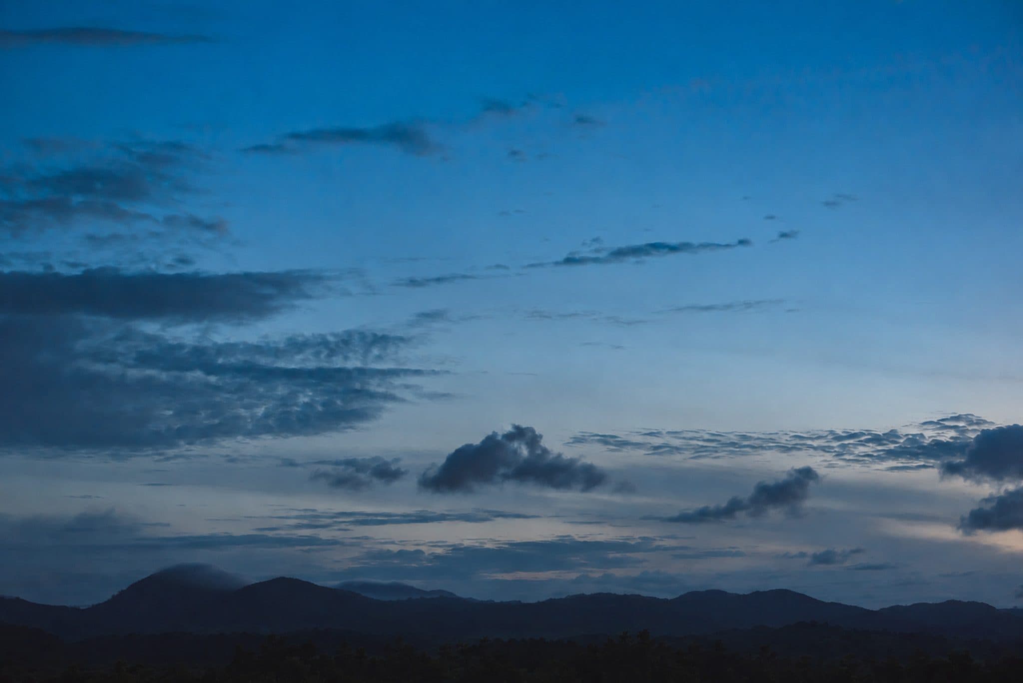 Evening sky over a dark ridge line