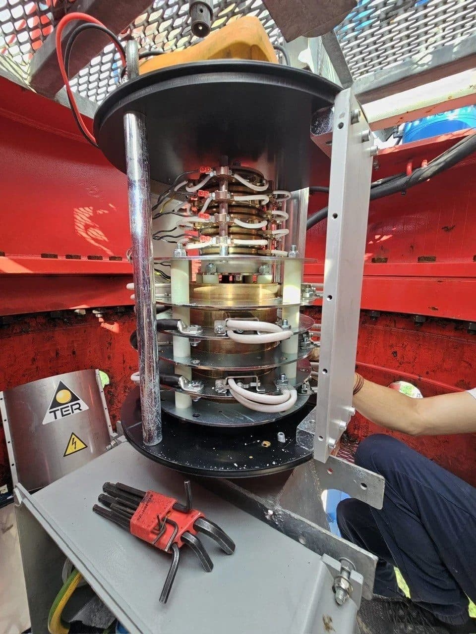 Technician servicing the electrical slip ring inside a tower crane